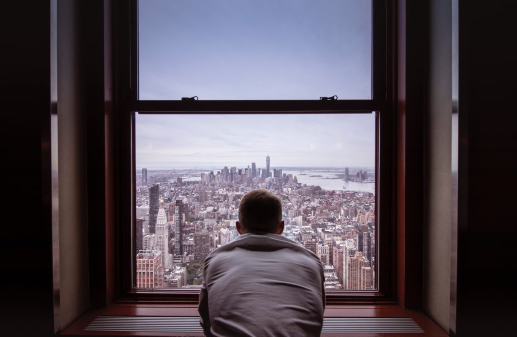 Man staring out window; New York City